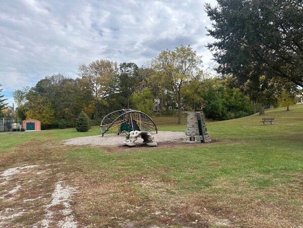 A playground with a swing set, climbing structures, and a small shed. - River, Marina, Park, Casino, EZ to I-75, DT Toledo (Rossford)