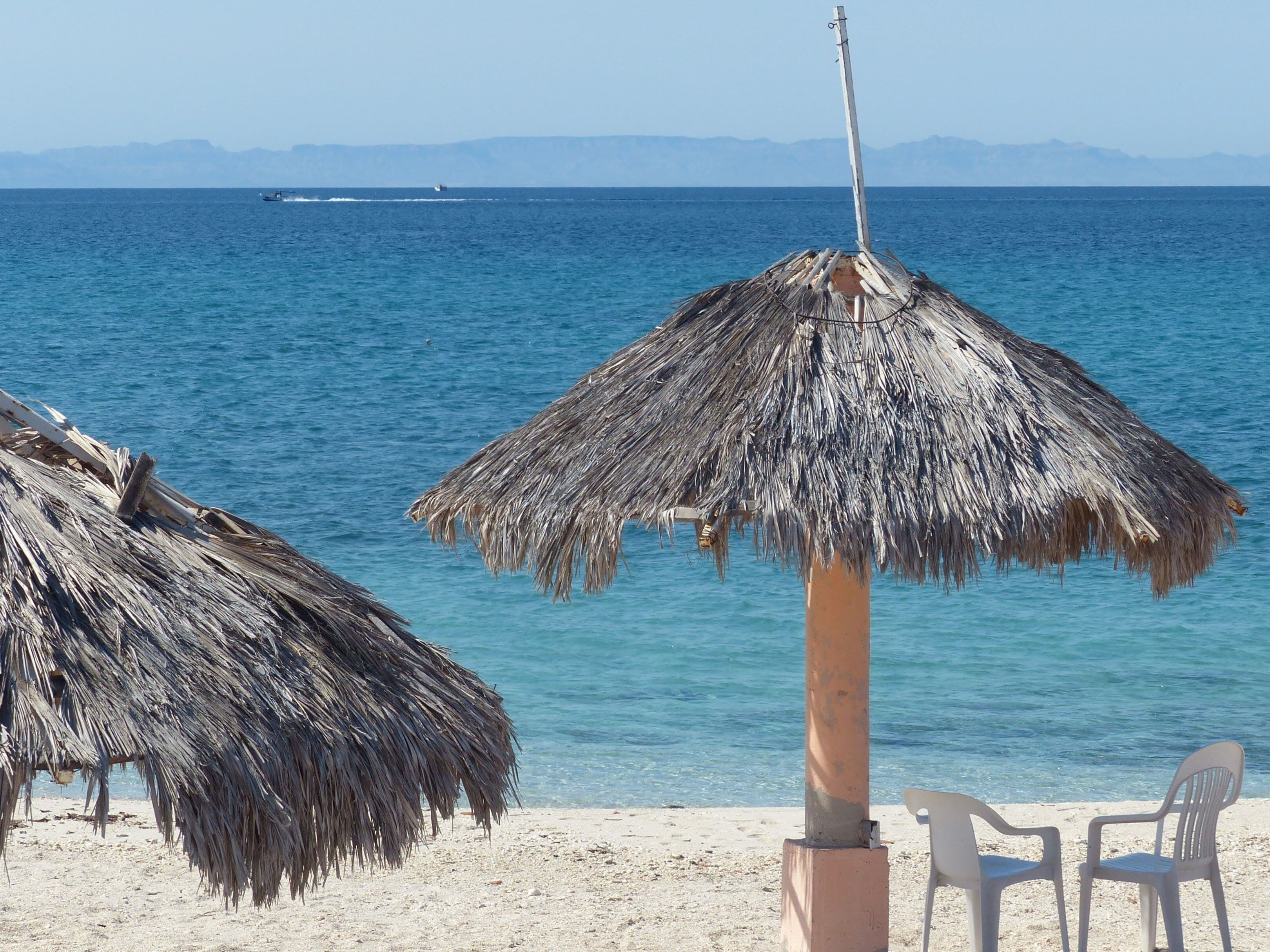 On the beach, white sand, sun-loungers, beach towels