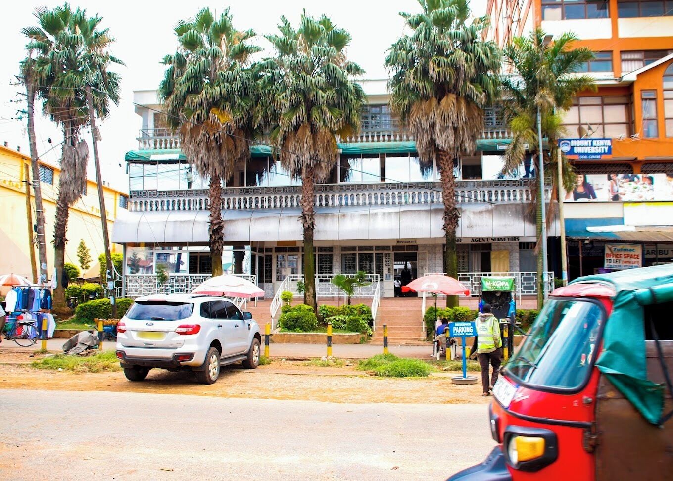 A building with a restaurant and an agent surveyors office.