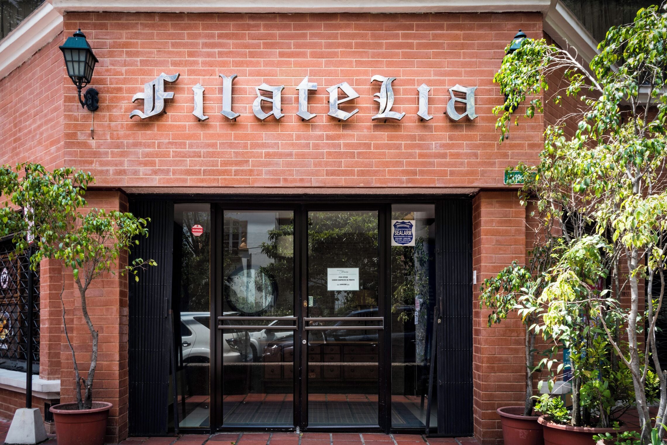 A brick building with a sign that reads "FlateLia."