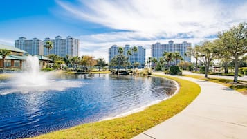 A park with a fountain, a pond, and a walking path.
