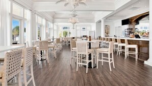 Ein großzügiger Essbereich mit hohen Decken, weißen Wänden und einer großen Chandelier.