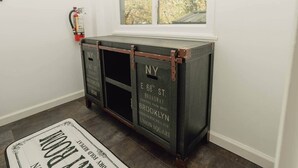 A dark wooden console with chalkboard-style writing indicating addresses in Brooklyn. - First Floor Getaway in Meadville (West Mead Township)