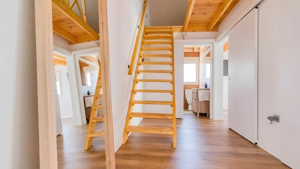 A wooden staircase in a modern interior with white walls and wooden floors. - Vacation Villa 'Adrián' with Mountain View, Wi-Fi and Air Conditioning (Las Palmas)