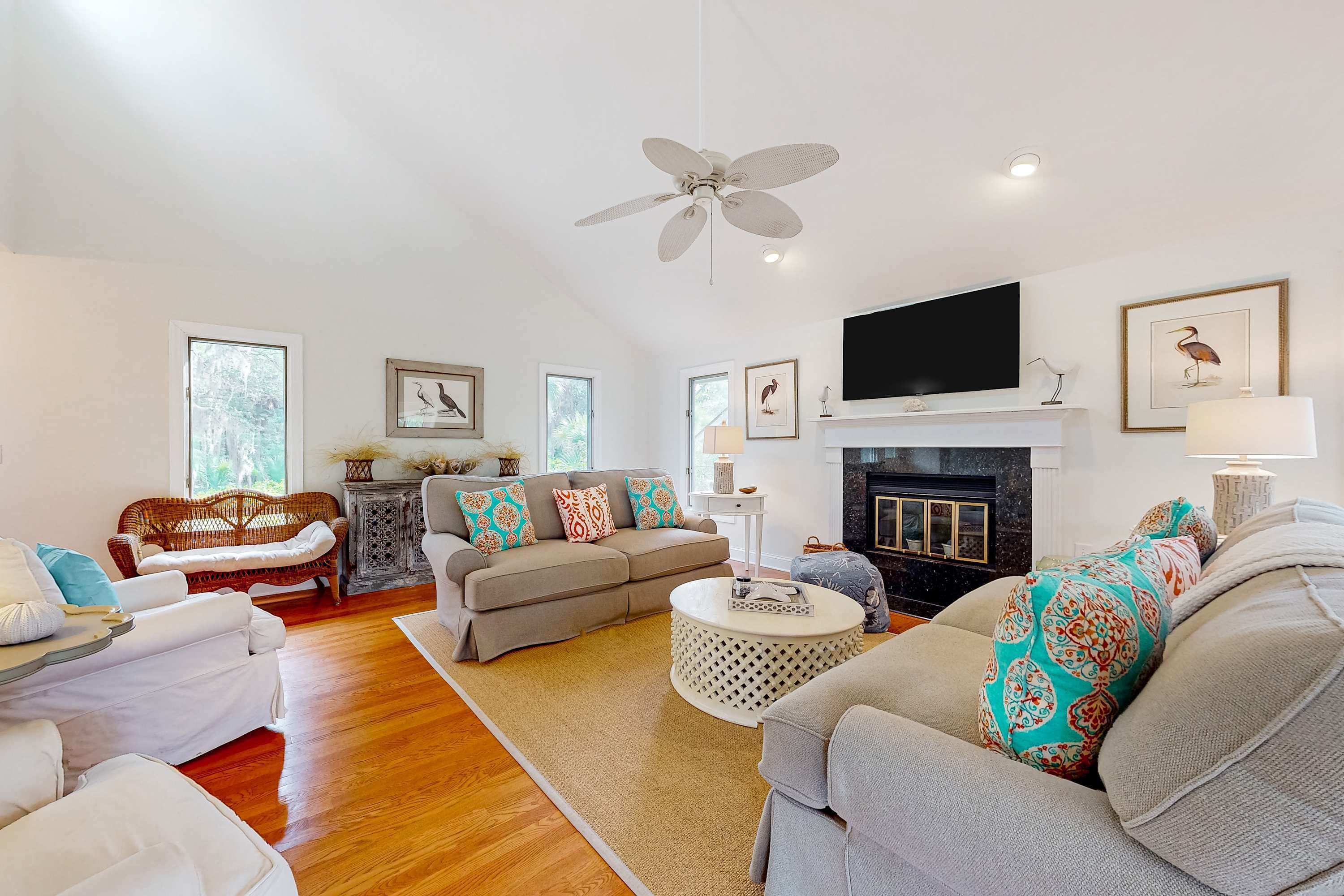A spacious living room with a fireplace, comfortable seating, and a flat-screen TV.