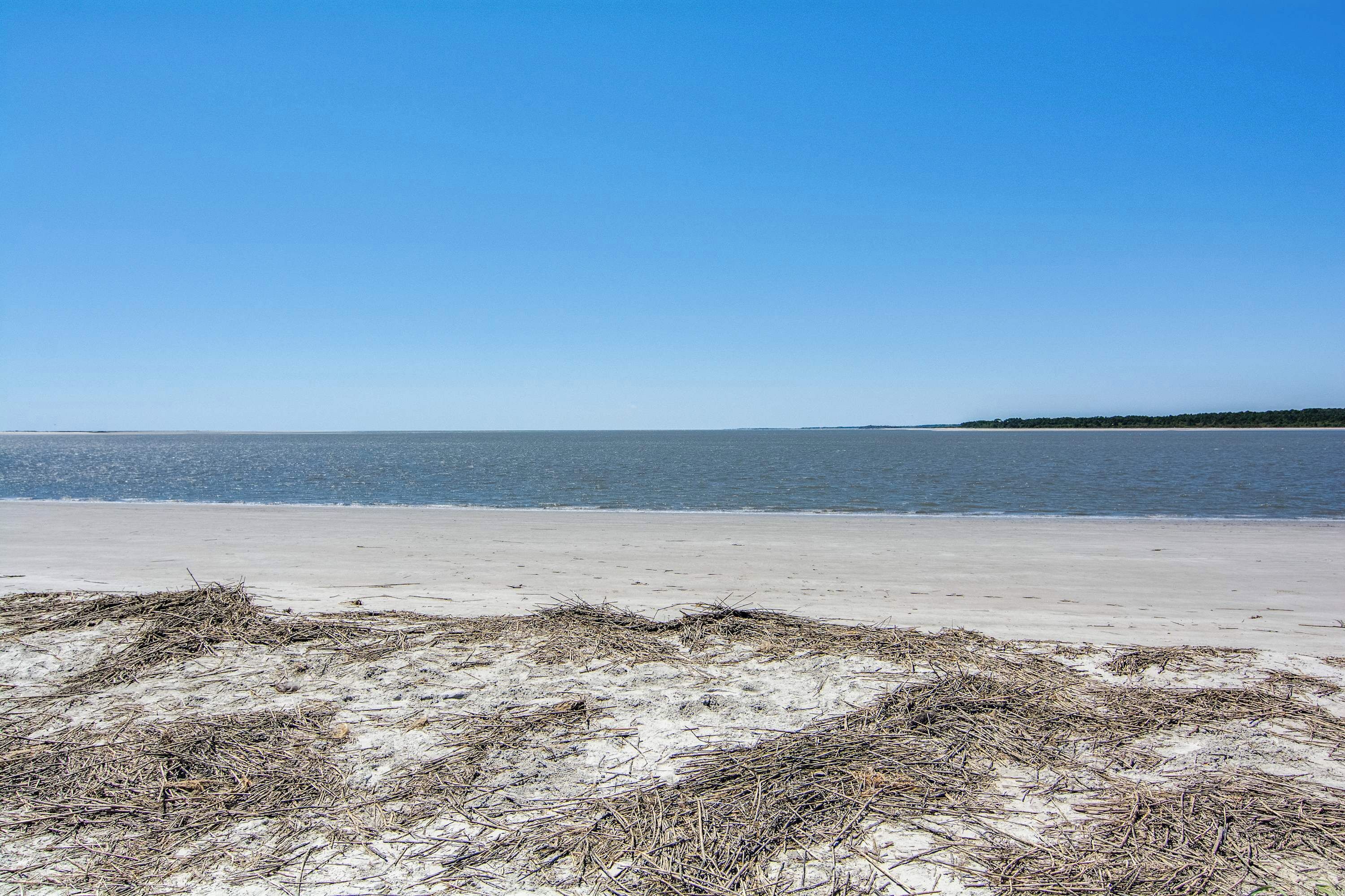 A beach with clear skies and calm water.