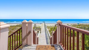 A wooden staircase leading to a beach with a clear view of the ocean. - Gorgeous Beachfront Home w/ Oceanfront Views, Deck, Beach Boardwalk & WiFi (Folly Beach)