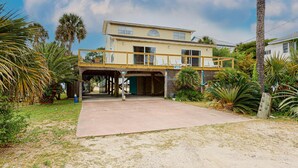 A two-story house with a covered driveway and a balcony.