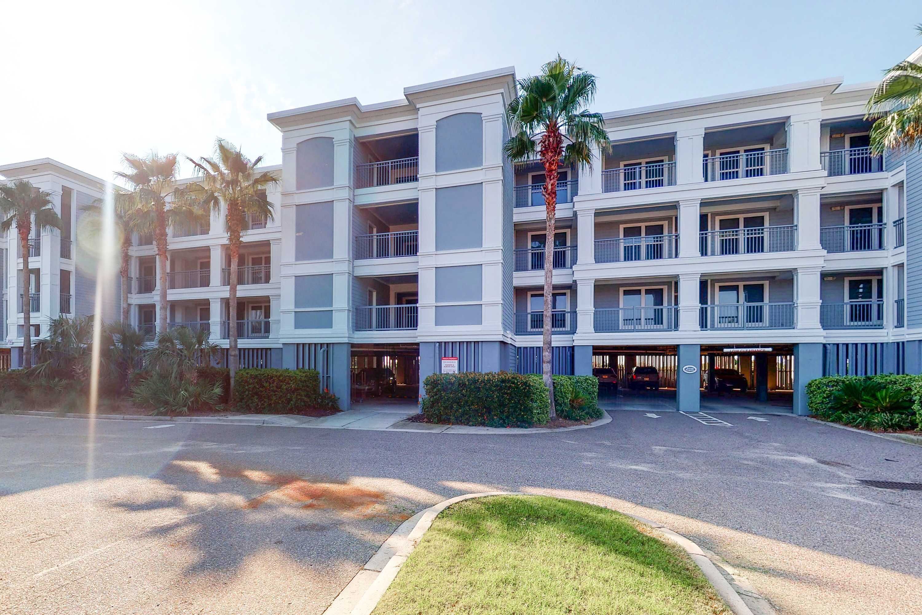 Un hôtel à plusieurs étages doté d’une cour intérieure, de balcons et d’un parking souterrain.