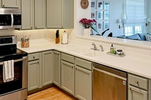 Fridge, microwave, oven, stovetop - Stylish Oceanview Condo: Pool, Parking & Prime Location! (Folly Beach)