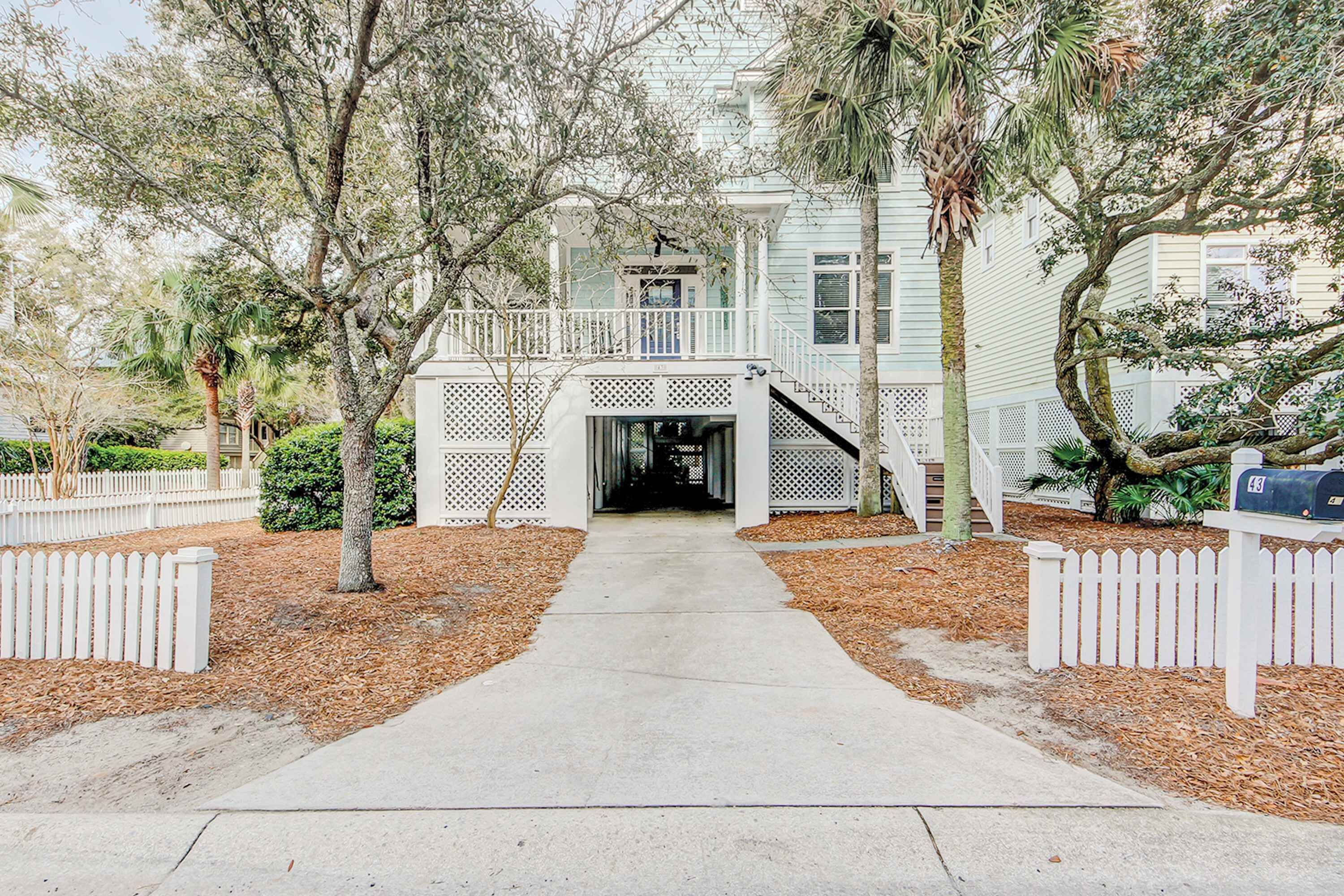 A house with a covered porch, a staircase leading to the entrance, and a mailbox on the right.