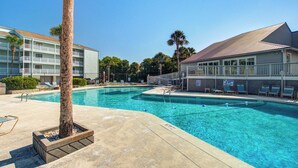A swimming pool with lounge chairs and a palm tree. - First-floor villa w/ magnificent river view & community pool/dock/tennis courts (Folly Beach)