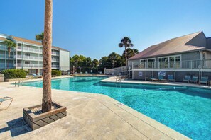 A swimming pool with lounge chairs and a palm tree. - First-floor villa w/ magnificent river view & community pool/dock/tennis courts (Folly Beach)