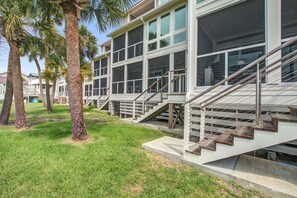 A modern building with multiple floors, large windows, and a staircase leading to the upper levels. - First-floor villa w/ magnificent river view & community pool/dock/tennis courts (Folly Beach)