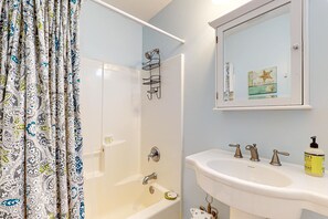 A bathroom with a bathtub, a shower, a sink, and a mirror. - Dog-Friendly, Downtown Folly Beach Condo w/Free WiFi, Flatscreen TVs & more (Folly Beach)