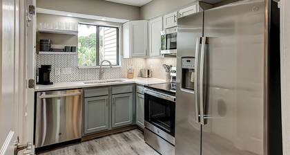 Fully updated condo with serene view, enclosed balcony, WiFi, W/D, pool, & gym