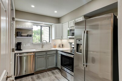 Fully updated condo with serene view, enclosed balcony, WiFi, W/D, pool, & gym