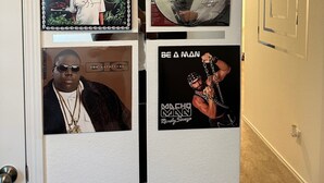 A wall with framed album covers and posters. - Cozy Hideaway with Pool – Relax & Unwind Just Off the Highway (Maxwell)
