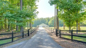 A paved pathway leading to a building with a fenced area, surrounded by trees. - Southern Comfort Near Historic Dtwn Rockmart (Rockmart)