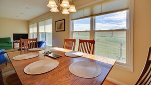A dining area with a wooden table, chairs, and a chandelier. - Peaceful & Convenient Country Retreat in Lexington (Lexington)