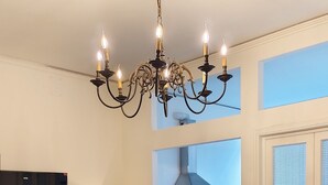 A dining area with a chandelier, a television, and a coffee machine. - B&B Cherubini 13 (Florence)