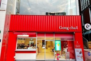 A red storefront with the name "Gong cha" and a sign indicating "PICK UP + GO".