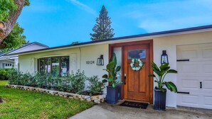A single-story house with a front door, number 10124, and a garage door. - Large heated pool home with backyard oasis, AC and Wifi (Seminole)