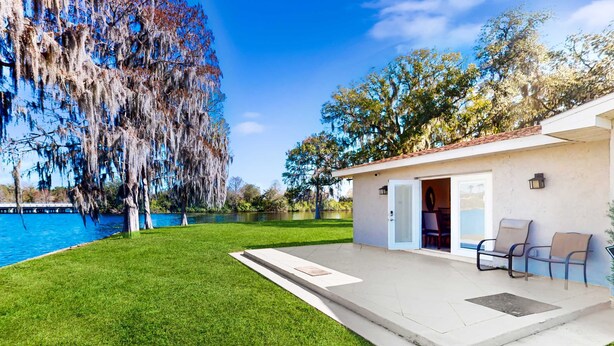 A house with a patio, a pool, and a view of the water. - Riverfront home near downtown Tampa with panoramic river views streaming WD (Tampa)