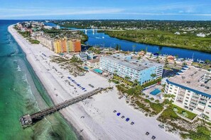 A coastal resort with a beach, a pier, and a river.