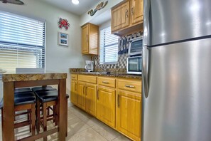 Fridge, microwave, coffee/tea maker, cookware/dishes/utensils
