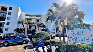 A modern building with a sign reading "Quiet Waters."