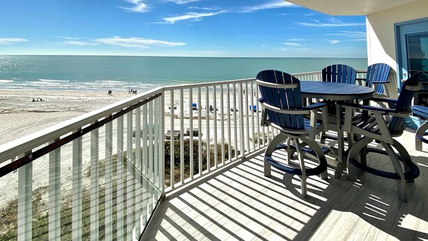 A balcony with a view of the beach and ocean. - 4th floor beachfront condo with private balcony views pool BBQ and AC (Indian Shores)