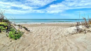 A sandy beach with a clear view of the ocean and a partly cloudy sky. - 4th floor beachfront condo with private balcony views pool BBQ and AC (Indian Shores)