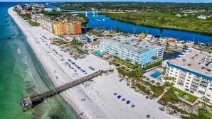 Ein Hotel an der Küste mit Blick auf den Strand, einen Steg und einen Fluss.