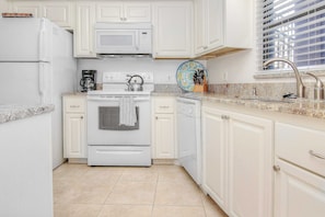 Fridge, microwave, oven, stovetop - Elegant 1st floor condo w private patio AC on site outdoor pool and gas grills (Belleair Beach)