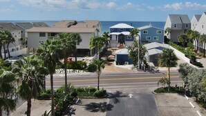 A coastal residential area with houses, palm trees, and a clear view of the ocean. - Waterfront condo with heated pool hot tub central AC and WD snowbird friendly (Indian Shores)