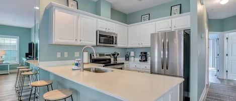 Apartment, Partial Ocean View | Private kitchen | Coffee/tea maker, dining tables