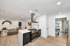 Open-concept design lets you prep meals while still being part of the fun in the living area. - *Pool | Modern Escape with Chic Vibes (Stafford)