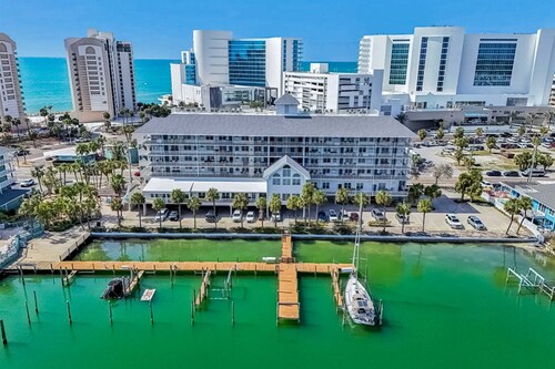 Steps to Gulf beaches family friendly condo with water views shared pool AC