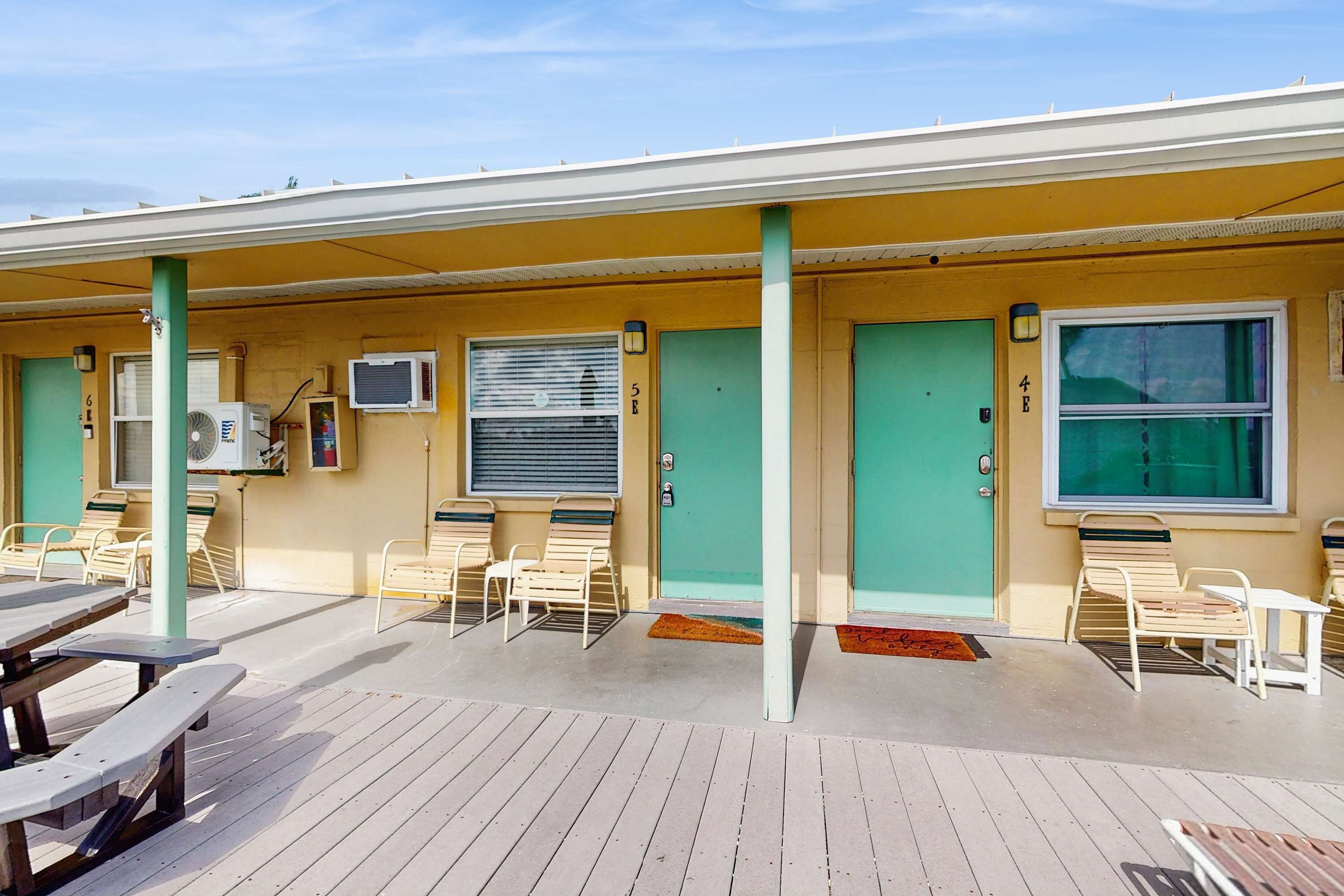 Un motel doté d’un patio couvert, d’un espace extérieur aménagé avec des sièges et d’une piscine.