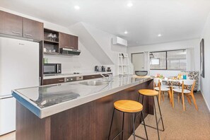 Microwave, oven, dishwasher, dining tables