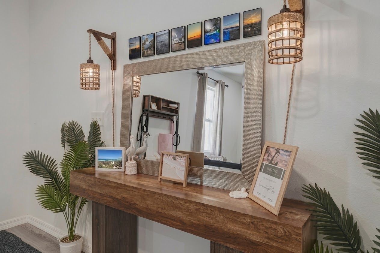 A reception desk with a mirror, framed pictures, and a wooden counter.
