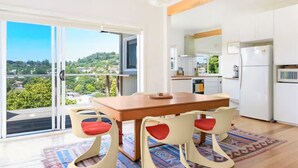Una cucina moderna con mobili bianchi e un tavolo da pranzo in legno.