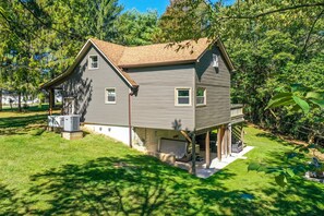 A two-story house with a covered porch, a small deck, and a large yard. - Private Pond · Hot Tub · Game Room · Hocking Hills (Logan)