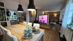 Villa – superior, 4 soverom, ikke-røyk, hageutsikt | Oppholdsområde | En 75-centimeters Flatskjerm-TV med digitale kanaler samt TV og peis