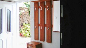A room with a wooden wardrobe, a small wooden cabinet, and a potted plant near the entrance. - Awesome apartment in Novi Vinodolski with WiFi (Novi Vinodolski)