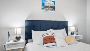 A neatly arranged hotel room with a large bed, two bedside tables, and a framed picture on the wall. - THE LITTLE HAVANA AT RIVERSIDE #11 (Austin)