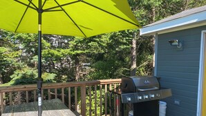 A wooden deck with a grill and a yellow umbrella. - Spacious Chester Home with Spectacular Ocean Views! (Chester)