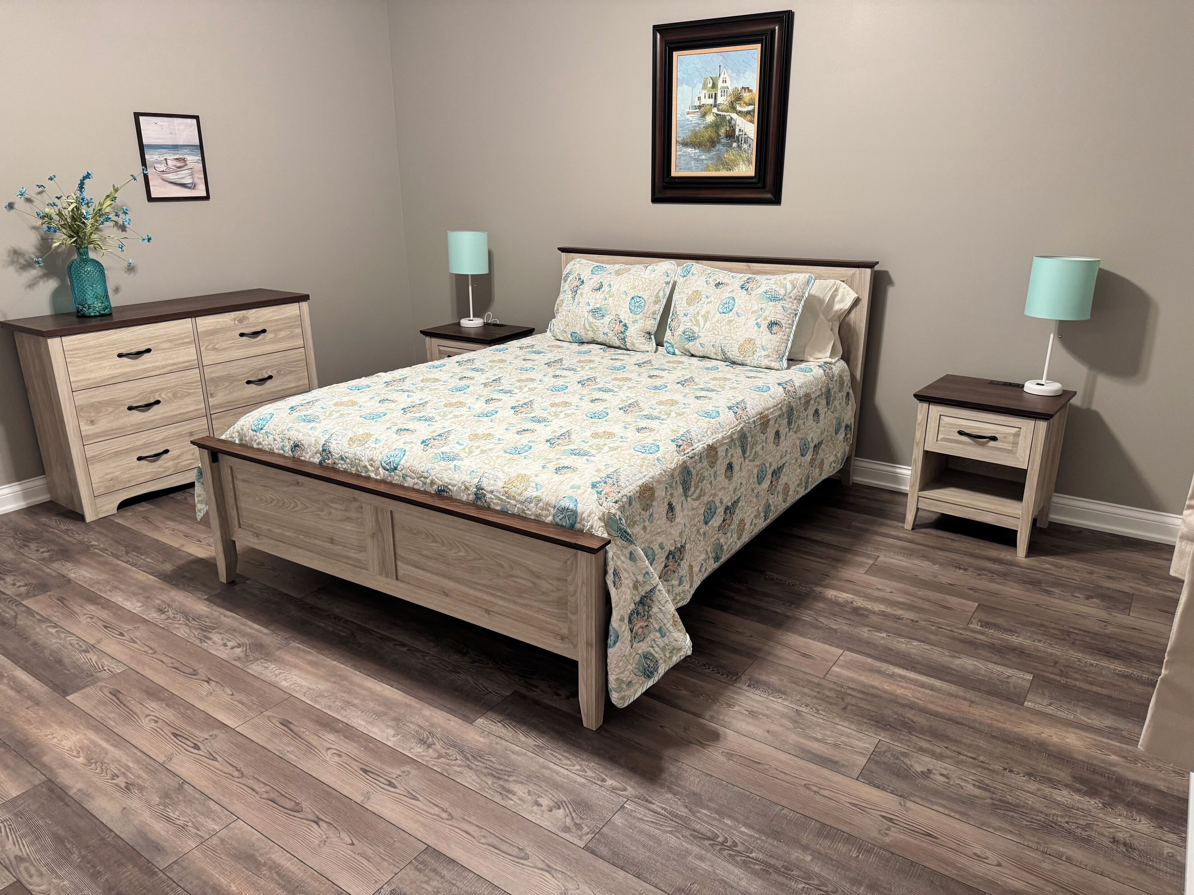 A bedroom with a wooden bed, two bedside tables, a dresser, and a wall-mounted picture.