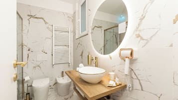 Suite Deluxe, balcón, vistas a la ciudad | Baño | Albornoces y zapatillas